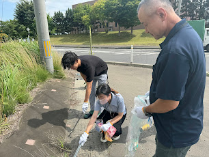 Photo of group members cleaning up around the office.