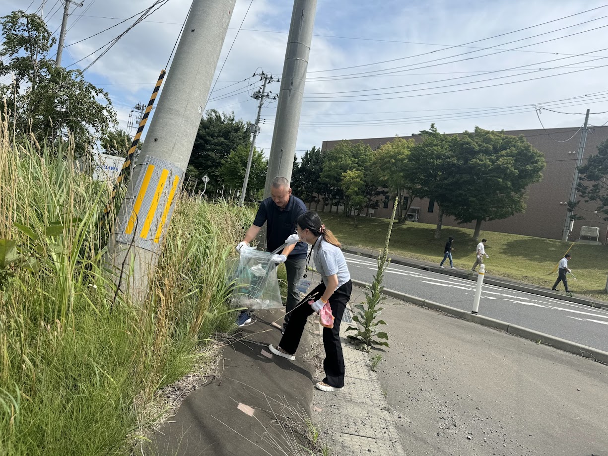 Photo of group members cleaning up around the office.